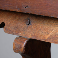 Scroll end supports and peg jointed construction on the Arts & Crafts oak console table by Beresford & Hicks with two drawers and shaped trestle supports