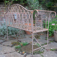 Painted wrought iron garden bench with Gothic arch back, scroll armrests and slatted seat