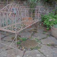 Painted wrought iron garden bench with Gothic arch back, scroll armrests and slatted seat