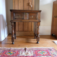 18th century country oak side table with a single panelled drawer, brass handles and baluster-turned front legs