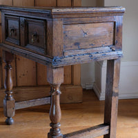 18th century country oak side table with a single panelled drawer, brass handles and baluster-turned front legs