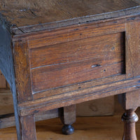 18th century country oak side table with a single panelled drawer, brass handles and baluster-turned front legs