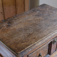 View of the ages wear on the 18th century country oak side table with a single panelled drawer, brass handles and baluster-turned front legs