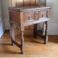 18th century country oak side table with a single panelled drawer, brass handles and baluster-turned front legs