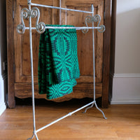 Early 20th-century wrought iron towel rail with scroll ends and aged painted finish