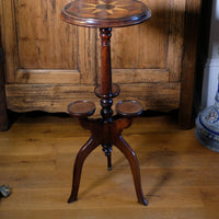 Antique Victorian mahogany tripod wine table with parquetry inlaid top and three lower rests