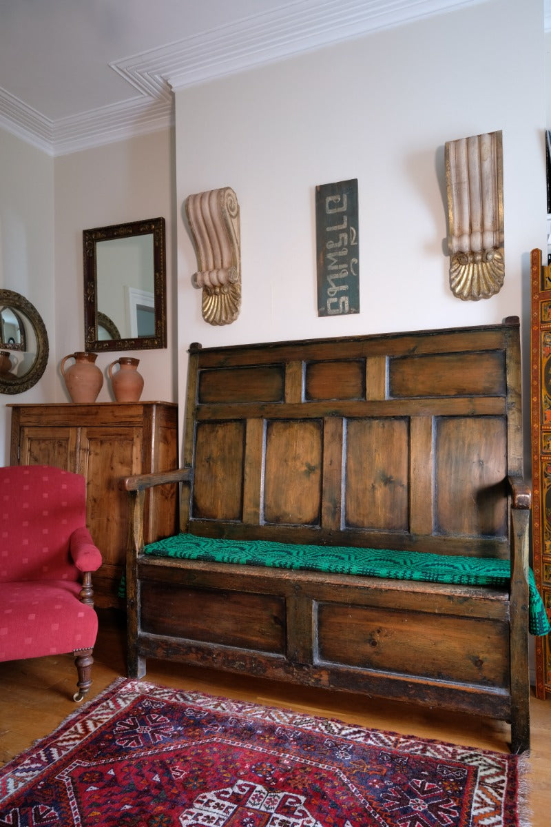19th century Welsh oak panelled hall settle with storage and green painted finish