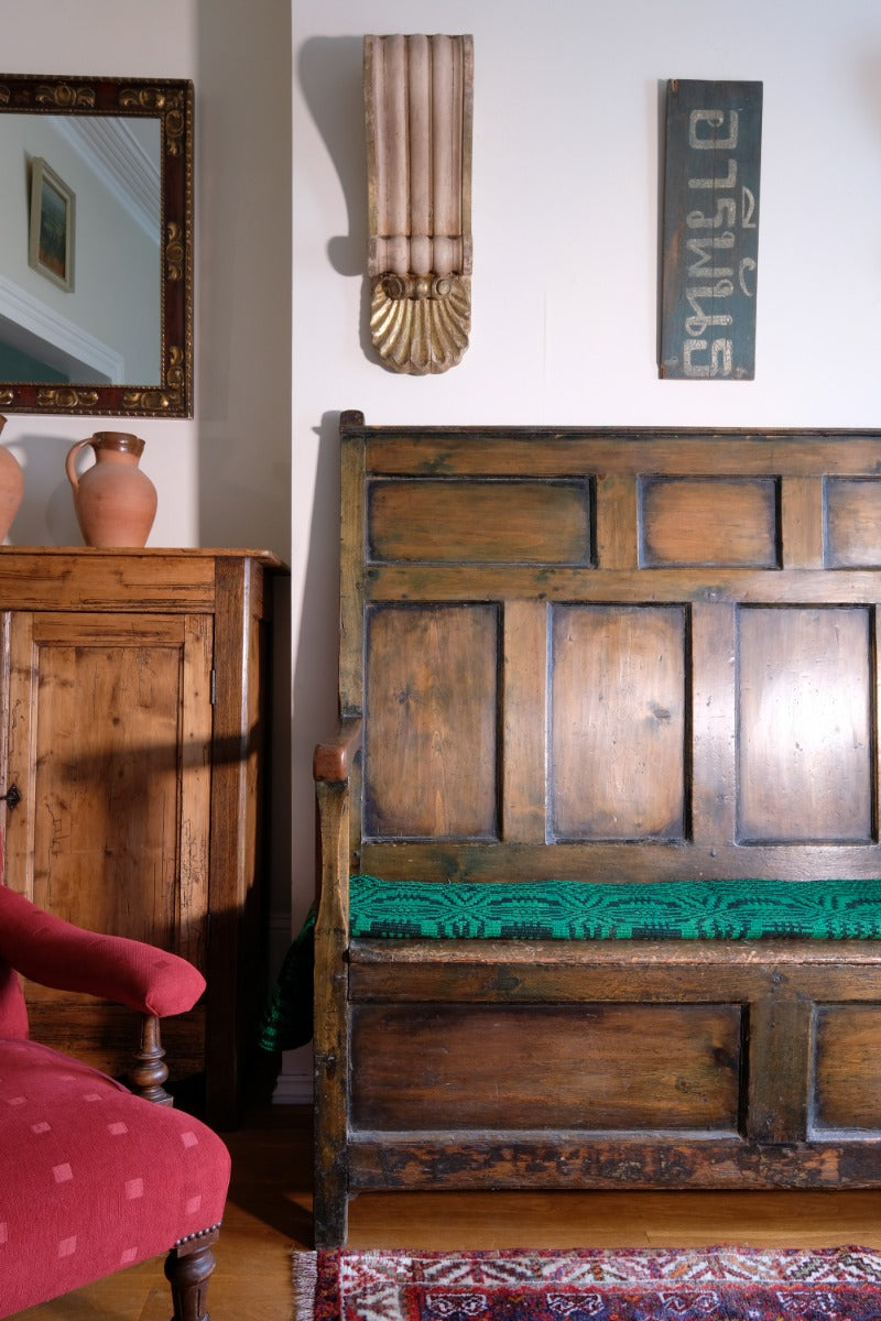 19th century Welsh oak panelled hall settle with storage and green painted finish