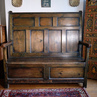 19th century Welsh oak panelled hall settle with storage and green painted finish