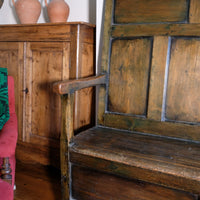 19th century Welsh oak panelled hall settle with storage and green painted finish