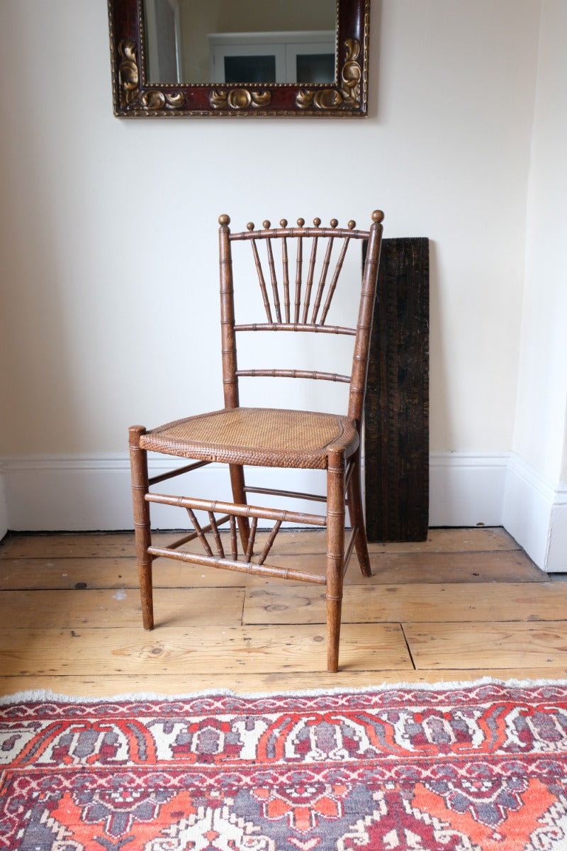 Regency faux bamboo painted chair with rattan seat and sunburst back, circa 1820