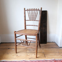 Regency faux bamboo painted chair with rattan seat and sunburst back, circa 1820
