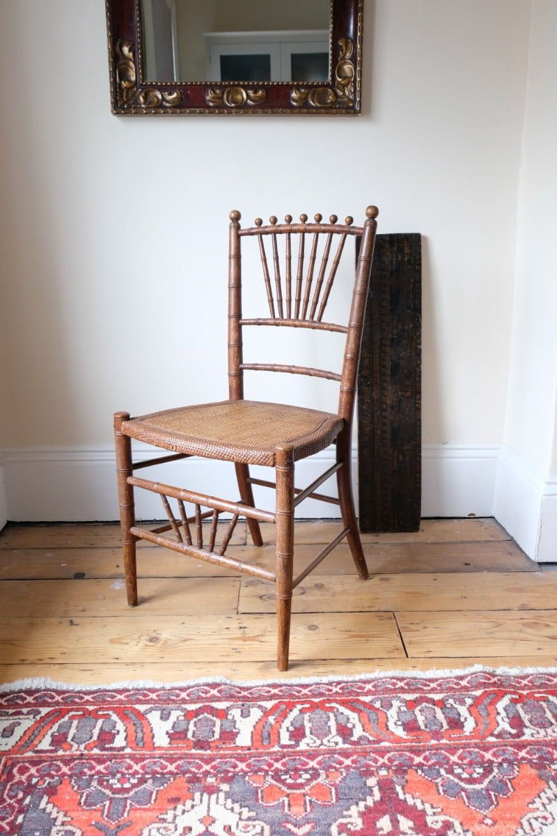 Regency faux bamboo painted chair with rattan seat and sunburst back, circa 1820