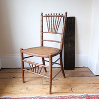 Regency faux bamboo painted chair with rattan seat and sunburst back, circa 1820