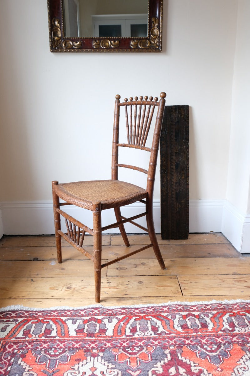 Regency faux bamboo painted chair with rattan seat and sunburst back, circa 1820