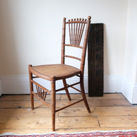 Regency faux bamboo painted chair with rattan seat and sunburst back, circa 1820