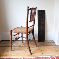 Regency faux bamboo painted chair with rattan seat and sunburst back, circa 1820