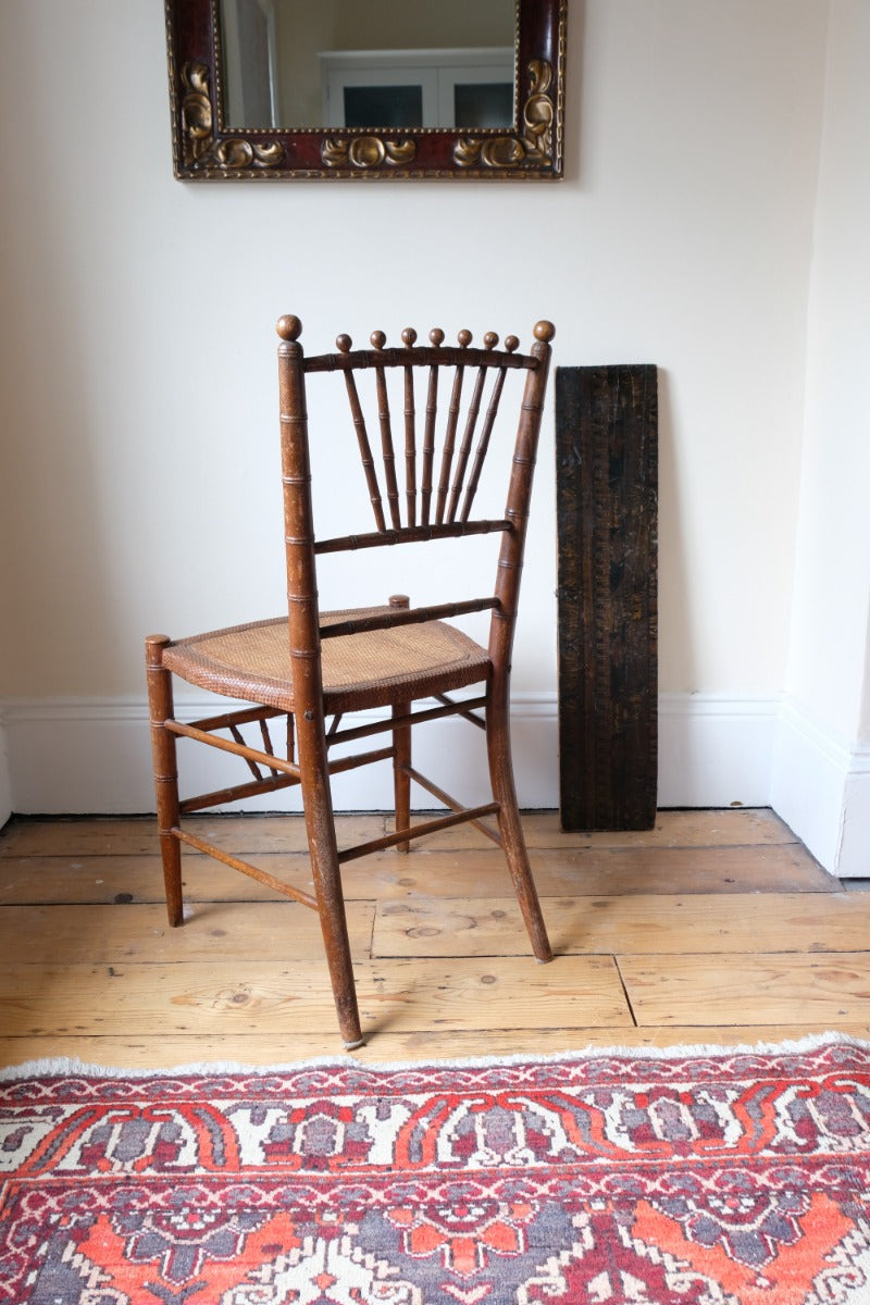 Regency faux bamboo painted chair with rattan seat and sunburst back, circa 1820