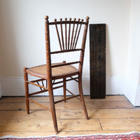 Regency faux bamboo painted chair with rattan seat and sunburst back, circa 1820