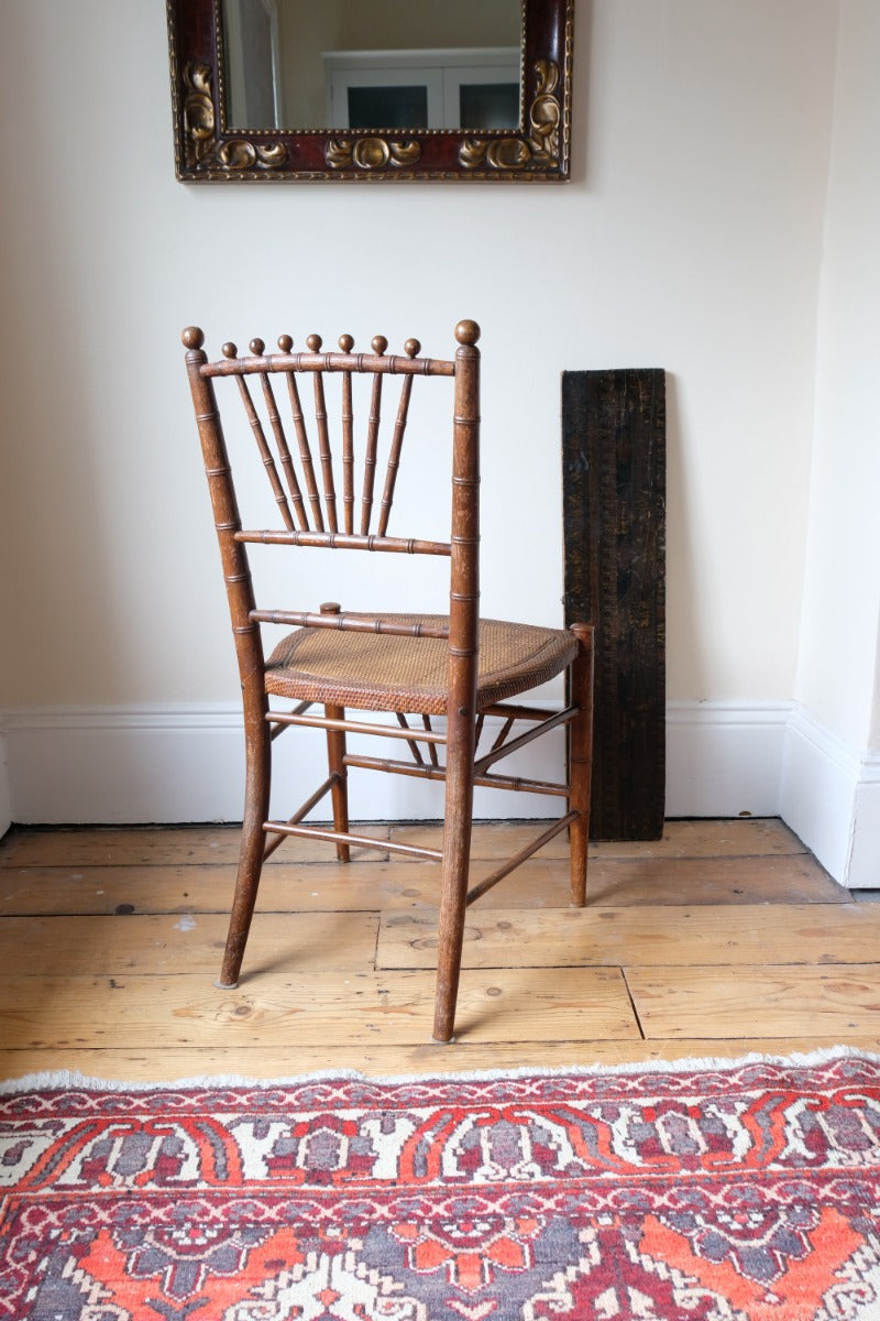 Regency faux bamboo painted chair with rattan seat and sunburst back, circa 1820