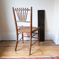 Regency faux bamboo painted chair with rattan seat and sunburst back, circa 1820