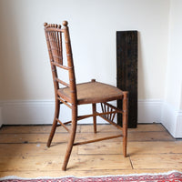 Regency faux bamboo painted chair with rattan seat and sunburst back, circa 1820