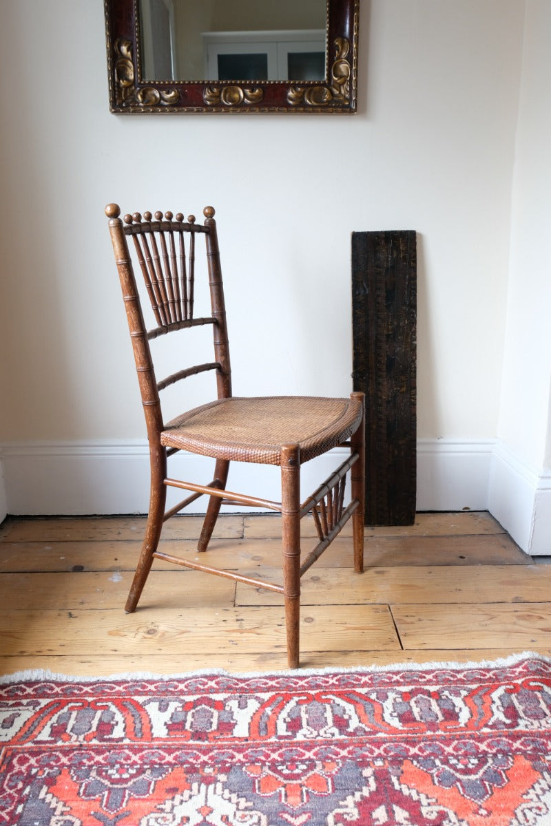 Regency faux bamboo painted chair with rattan seat and sunburst back, circa 1820
