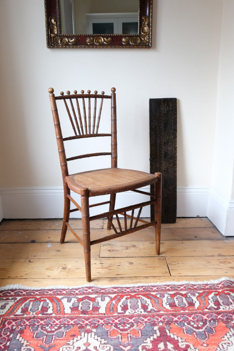 Regency faux bamboo painted chair with rattan seat and sunburst back, circa 1820