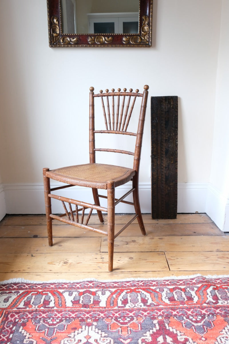 Regency faux bamboo painted chair with rattan seat and sunburst back, circa 1820