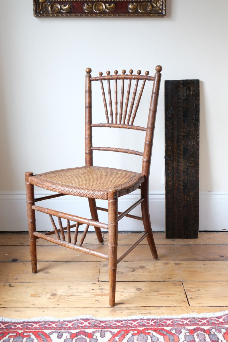 Regency faux bamboo painted chair with rattan seat and sunburst back, circa 1820