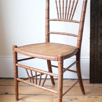 Regency faux bamboo painted chair with rattan seat and sunburst back, circa 1820