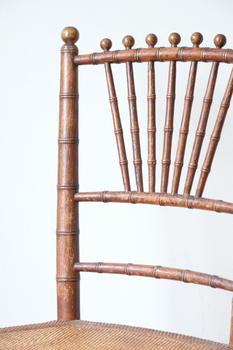 Regency faux bamboo painted chair with rattan seat and sunburst back, circa 1820