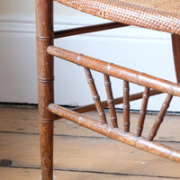 Regency faux bamboo painted chair with rattan seat and sunburst back, circa 1820
