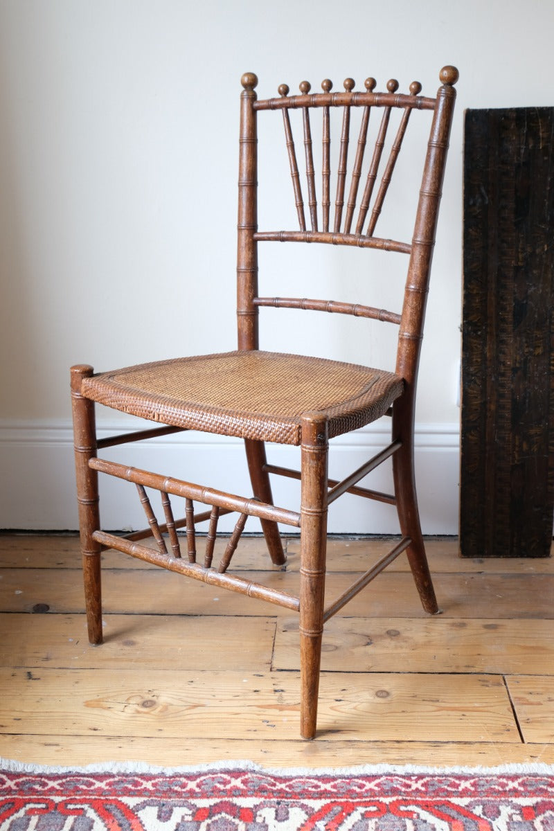 Regency faux bamboo painted chair with rattan seat and sunburst back, circa 1820