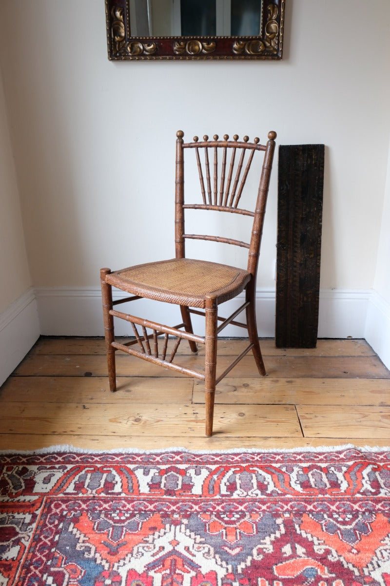 Regency faux bamboo painted chair with rattan seat and sunburst back, circa 1820