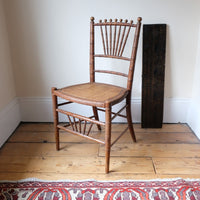 Regency faux bamboo painted chair with rattan seat and sunburst back, circa 1820
