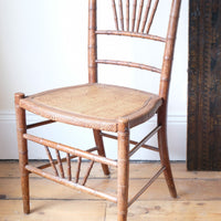 Regency faux bamboo painted chair with rattan seat and sunburst back, circa 1820