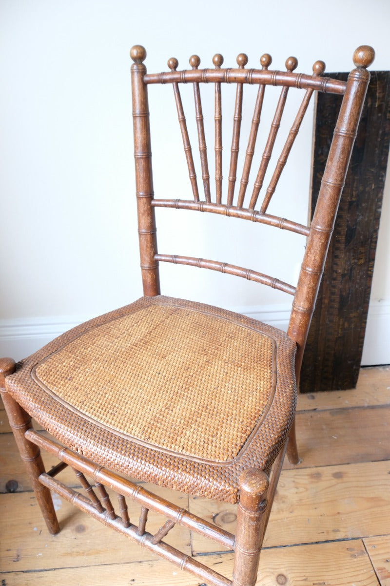 Regency faux bamboo painted chair with rattan seat and sunburst back, circa 1820