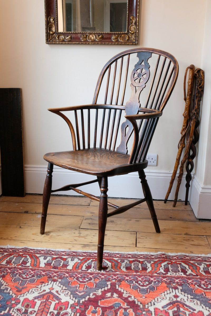Wheelback Windsor armchair with swept back arms and patina