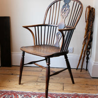 Wheelback Windsor armchair with swept back arms and patina