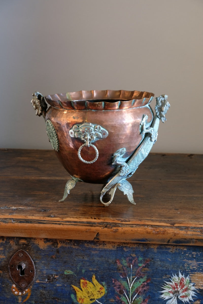 Side detail of brass dragon motif on Tibetan copper planter