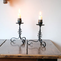 Pair of hand-forged Arts & Crafts wrought iron and copper candlesticks with spiral stems and floral drip trays