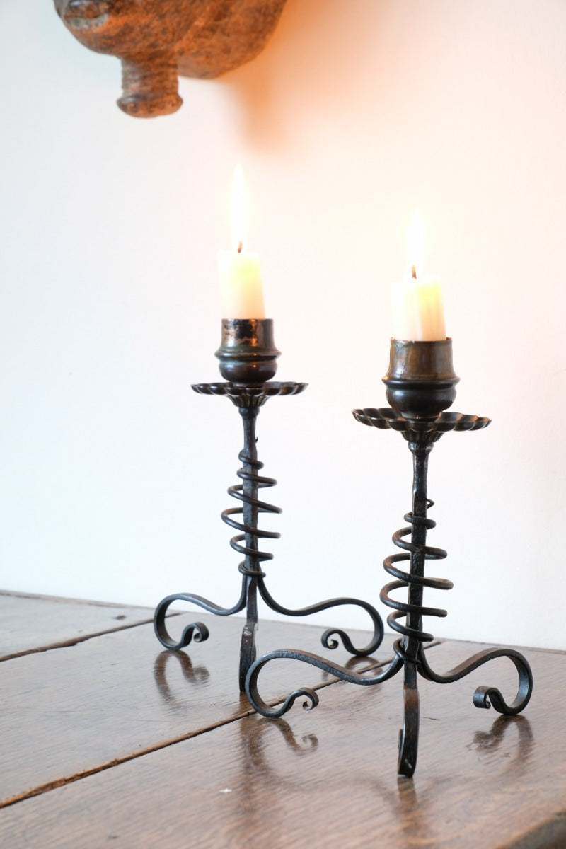 Pair of Arts & Crafts wrought iron candlesticks with copper drip trays
