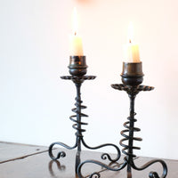 Pair of hand-forged Arts & Crafts wrought iron and copper candlesticks with spiral stems and floral drip trays
