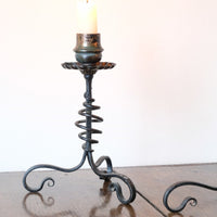 Pair of hand-forged Arts & Crafts wrought iron and copper candlesticks with spiral stems and floral drip trays