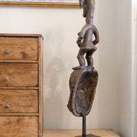 Guro fertility figure sculpture on stand Côte d’Ivoire hand‑carved wood