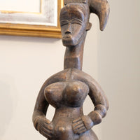 Stylized pregnant Guro sculpture with accentuated hips and breasts