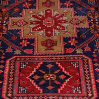 A vintage Kordi handmade wool rug runner with a geometric pattern primarily in blue and red colors.