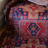 A vintage Kordi handmade wool rug runner with a geometric pattern primarily in blue and red colors.