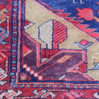 A vintage Kordi handmade wool rug runner with a geometric pattern primarily in blue and red colors.